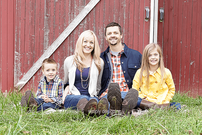 Family Photo of everyone sitting in the grass in front of a barn door