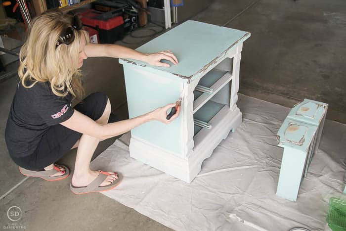 Use a brush to paint in corners and edges to re-paint bedside tables