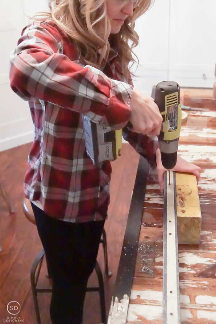 Drill pilot holes into angle iron for hanging spice racks