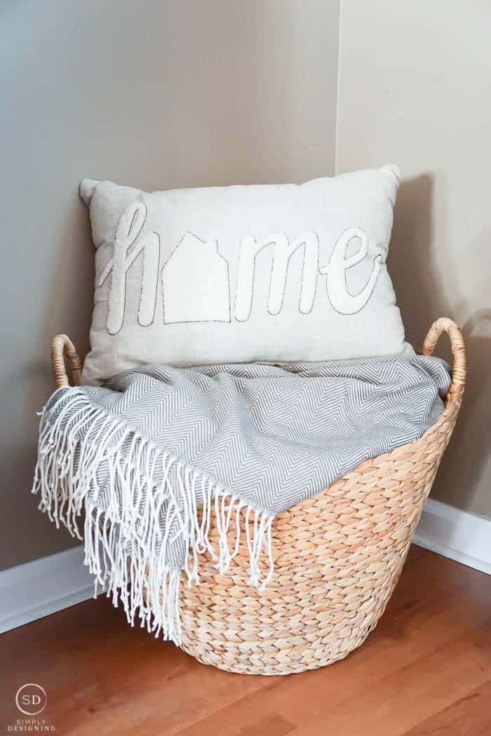 Basket with blanket and pillow in front room makeover