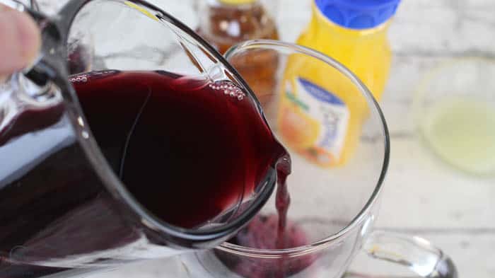 pour in grape juice for elderberry popsicles