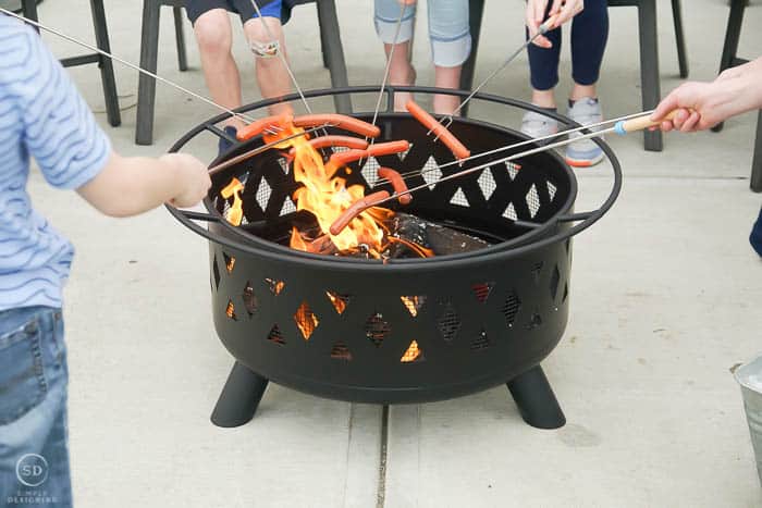 roasting hot dogs over fire pit