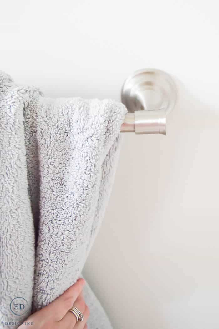 bathroom towels on new towel rack - close up detail of towel rack