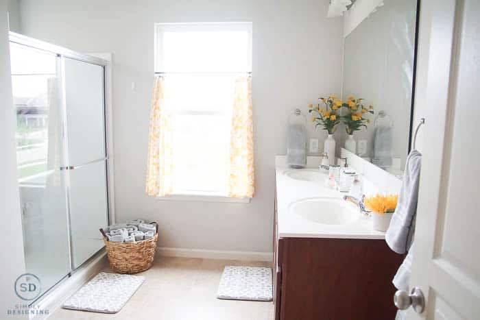 Budget-friendly bathroom makeover with pops of yellow and a lot of neutral gray.