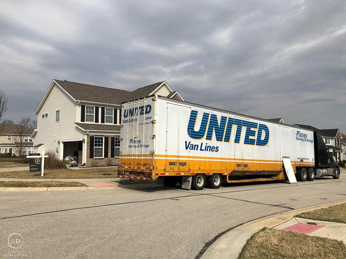 We Moved - moving truck in front of house