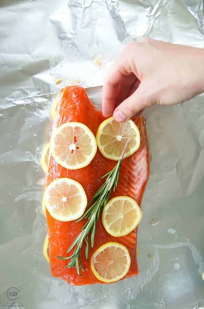 place rosemary and lemon on salmon in foil for honey lemon salmon