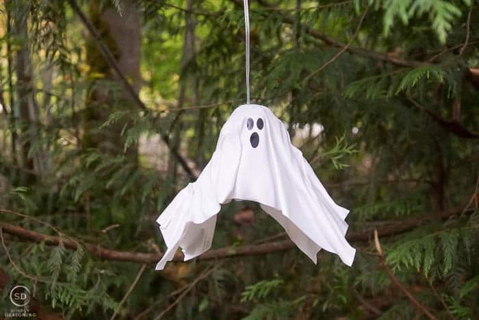 plastic white diy hanging ghost lantern hanging in a tree