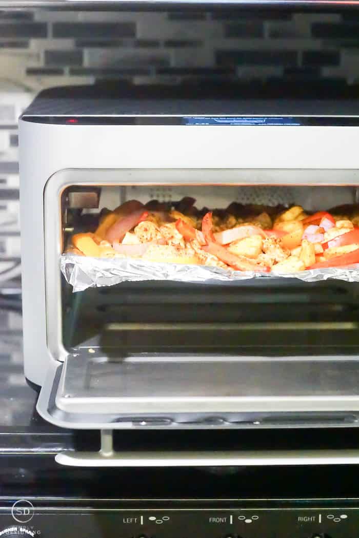 sheet pan fajitas coming out of the oven