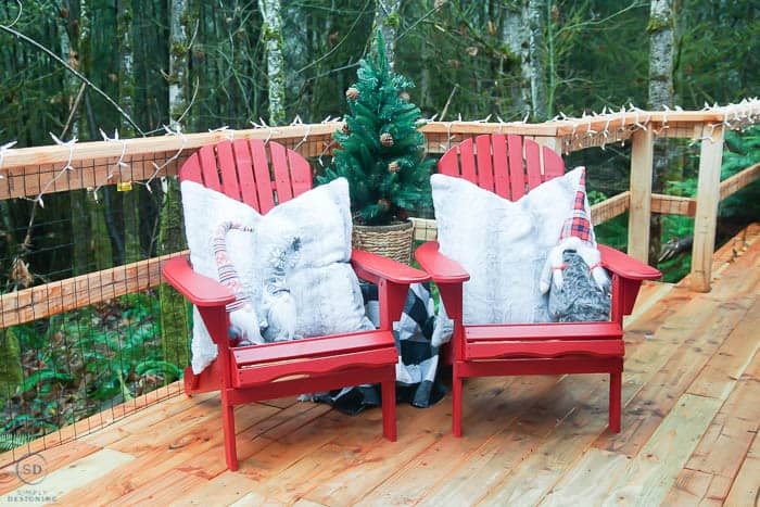 adirondack chairs painted red and decorated for christmas