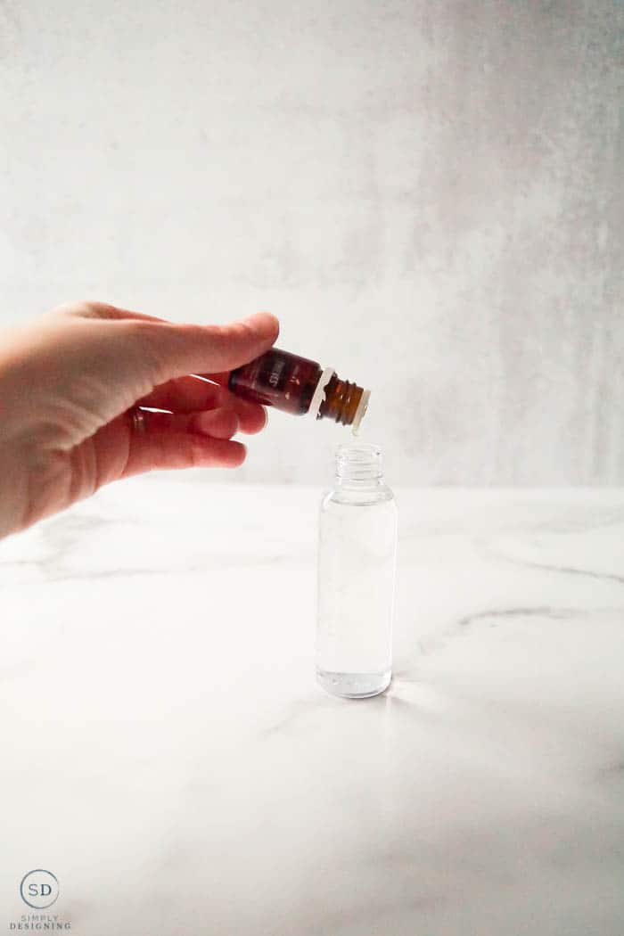 drop thieves essential oil into spray bottle