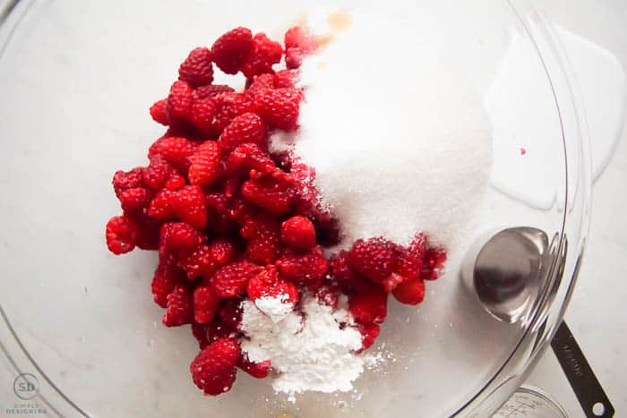 ingredients for raspberry crisp filling in a glass bowl
