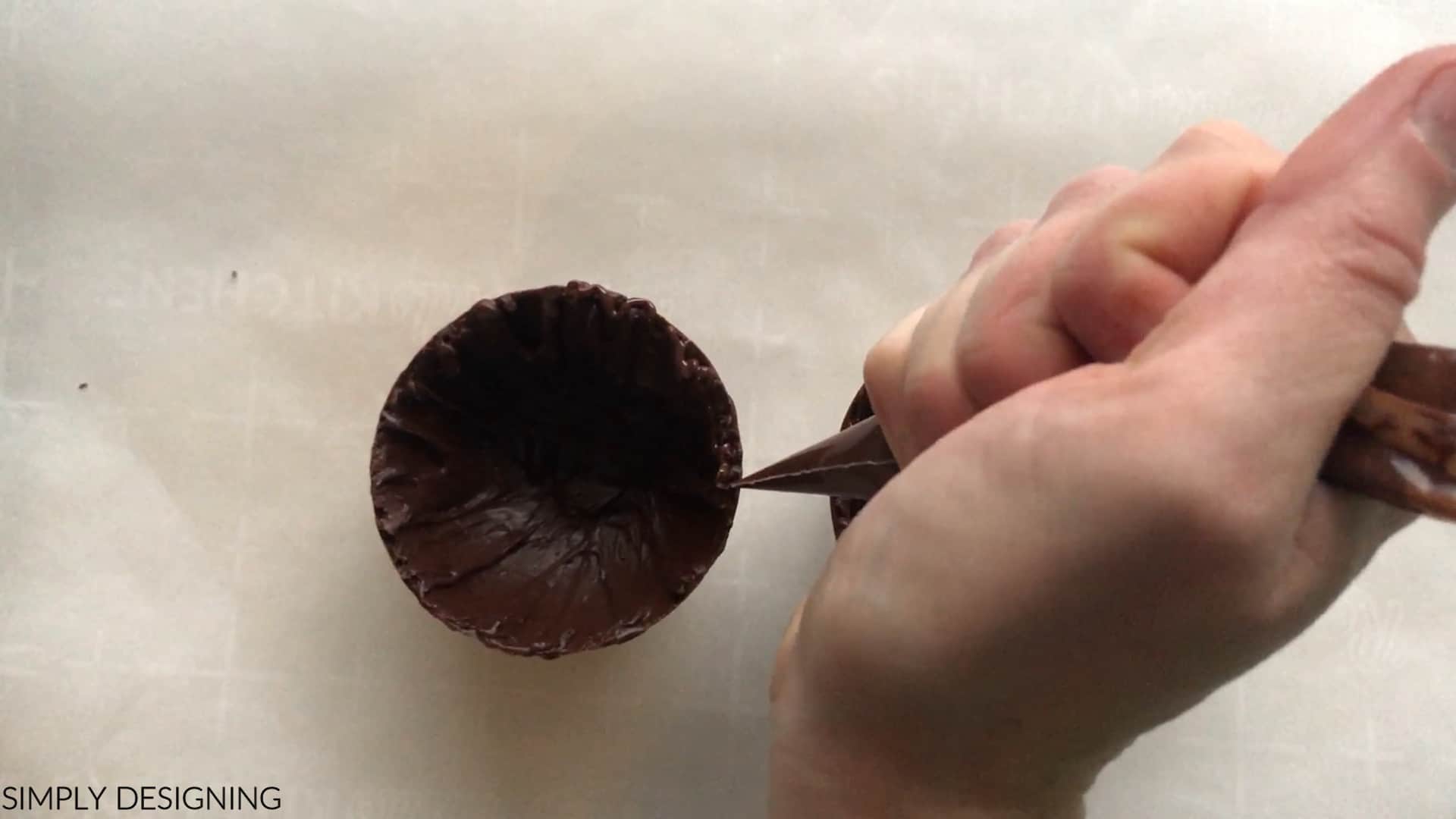 use melted chocolate to attach chocolate bomb