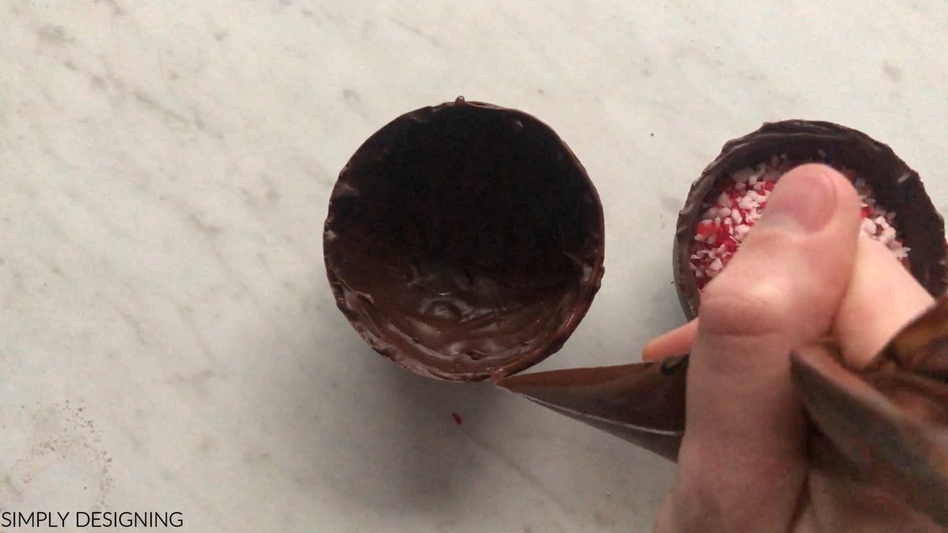 use melted chocolate to attach chocolate bomb