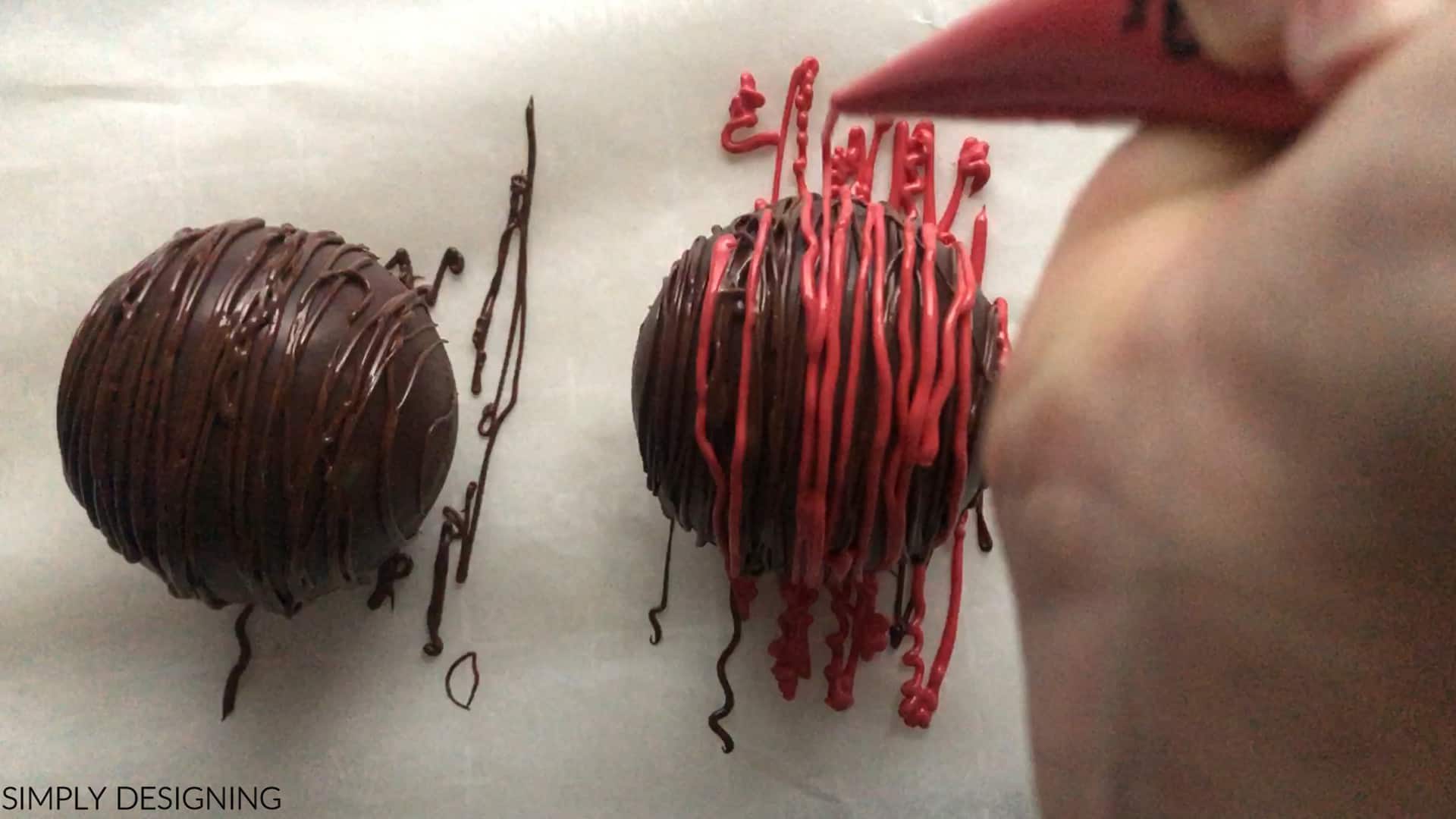 decorate hot cocoa bomb with red chocolate