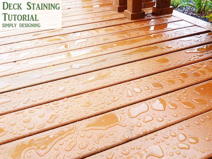 rain sitting on top of stained deck