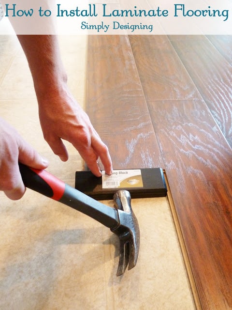 Installing+Floating+Laminate+Floors+Taping+the+wood+in+place1 | How to Install Floating Laminate Wood Flooring {Part 2}: The Installation | 16 |