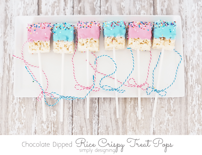 a plate of alternating pink and blue Chocolate Dipped Rice Crispy Treat Pop
