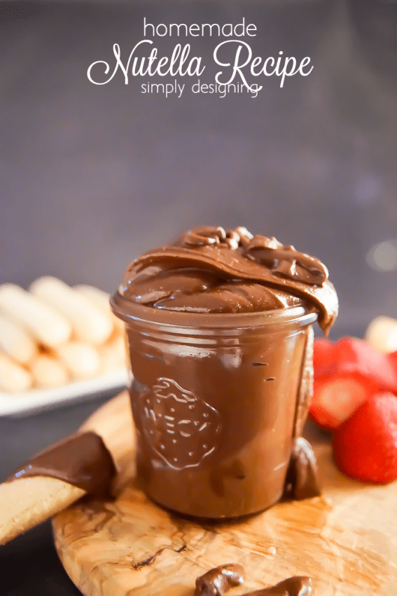 Nutella Recipes - Homemade Nutella in a jar with strawberries and ladyfingers on a wooden tray