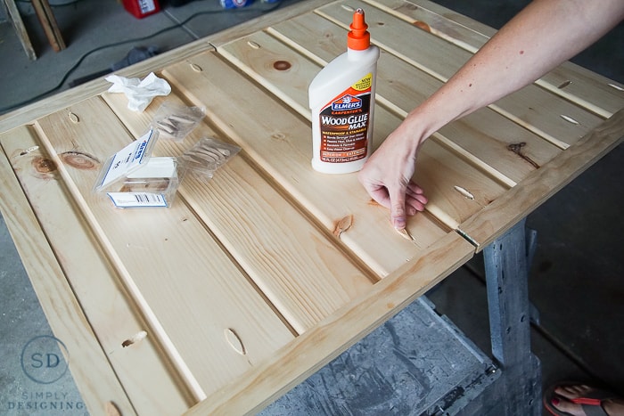 Using Elmer's Wood Glue Max to add wood plugs into the pock holes to keep the finished DIY baby gate
