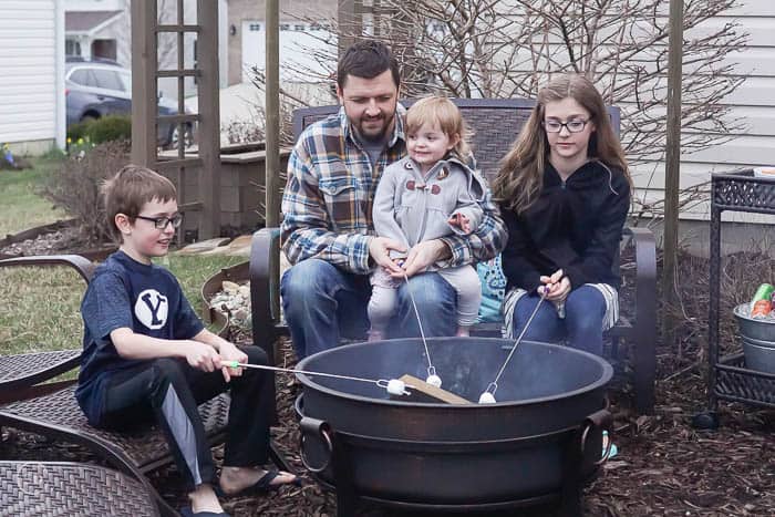 Sitting around a fire pit roasting marshmallows