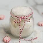 Peppermint Sugar Scrub in a glass jar with red and white twine around the jar