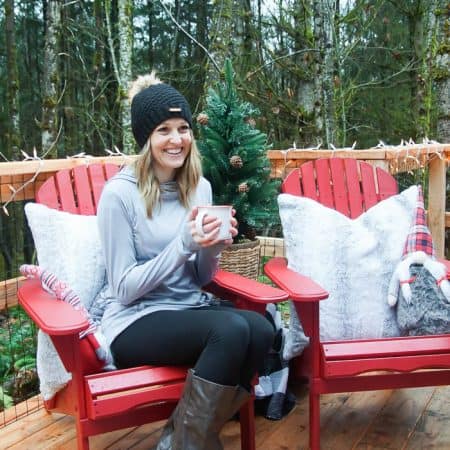 woman sitting in a red adirondack chair