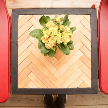herringbone side table with yellow flowers on top