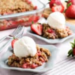 crisp made with rhubarb and strawberries served on a plate with ice cream